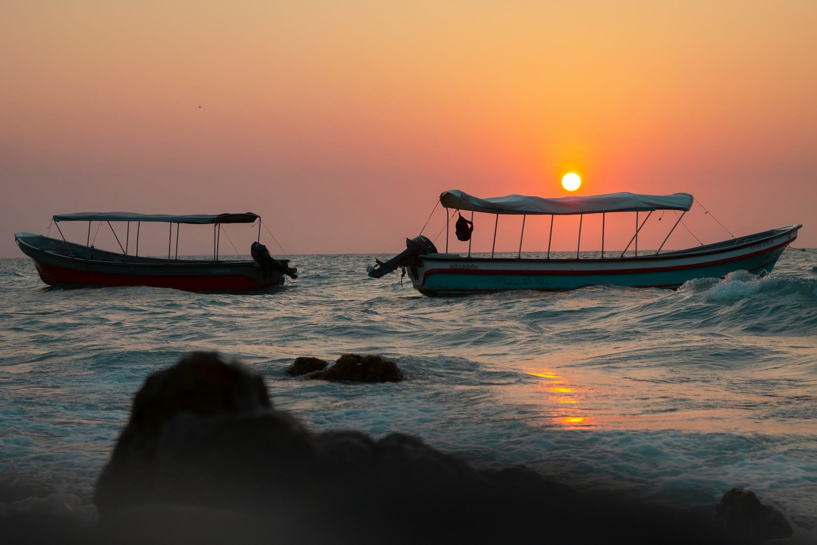 Boats sitting on the water in Calangute, Goa, India