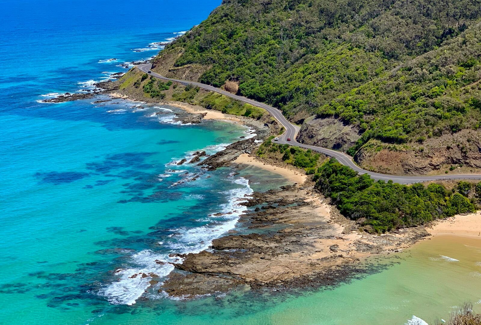 Aerial view of green mountain beside the blue sea on the Great Ocean Road, Victoria, Australia