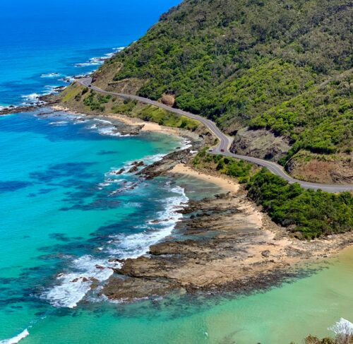 Aerial view of green mountain beside the blue sea on the Great Ocean Road, Victoria, Australia