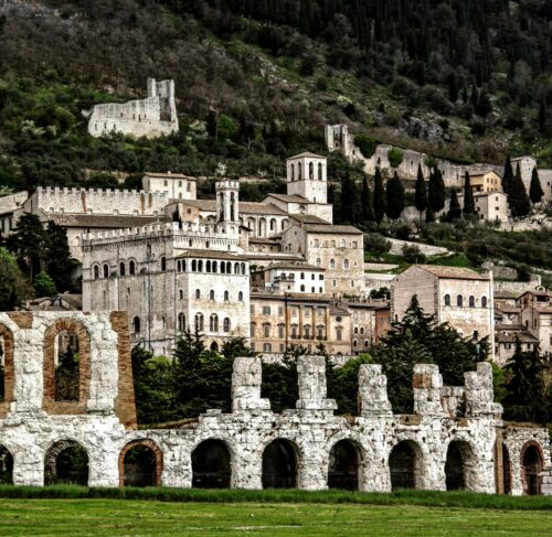 Brown building near a green grass field in Gubbio, Umbria, Italy