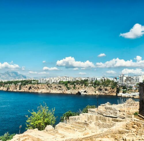 Body of water with a stone wall and flag in Kas, Antalya, Turkey
