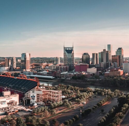 Football stadium next to a building and road in Nashville, Tennessee, United States