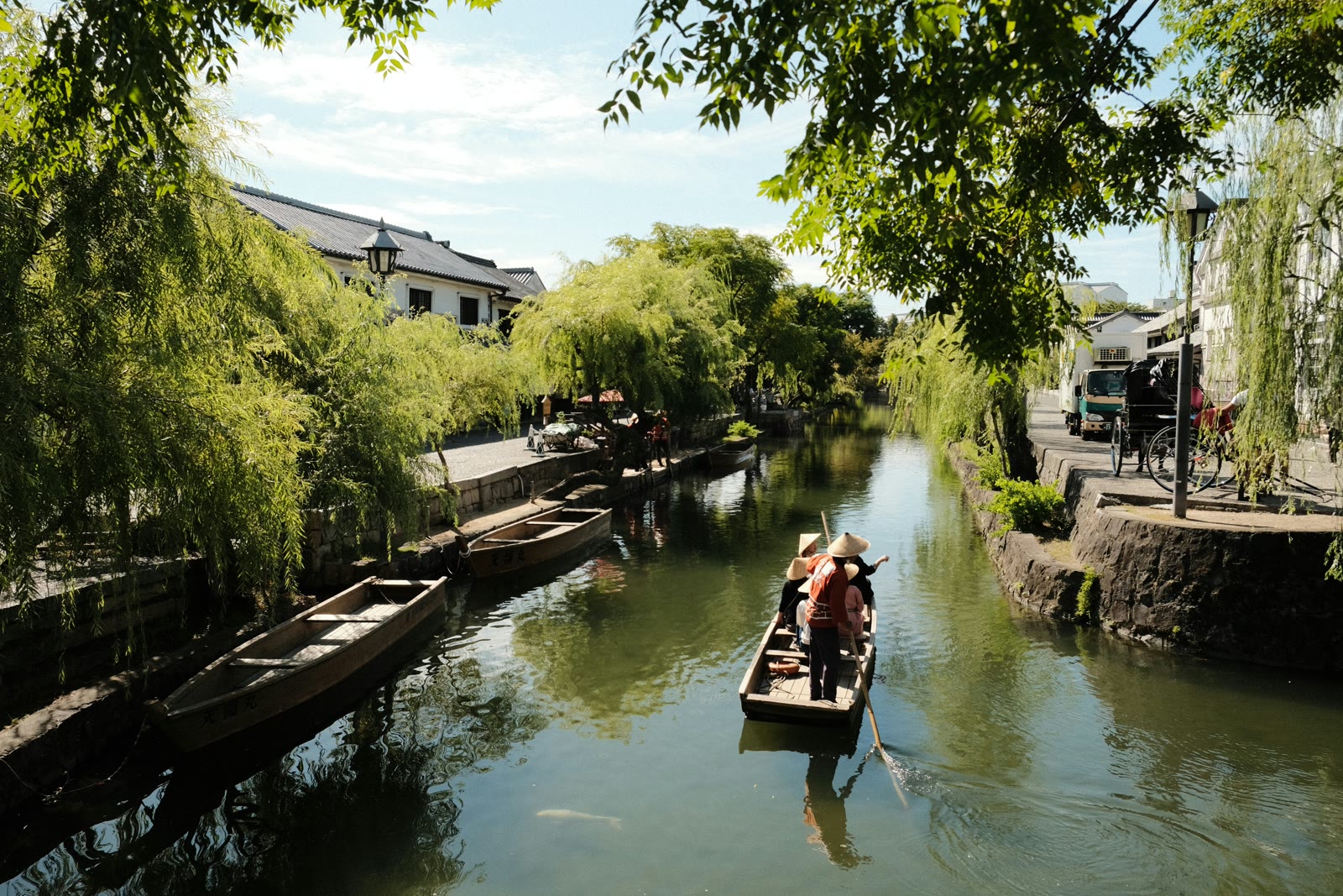 Person in a small boat on a river in Okayama, Japan