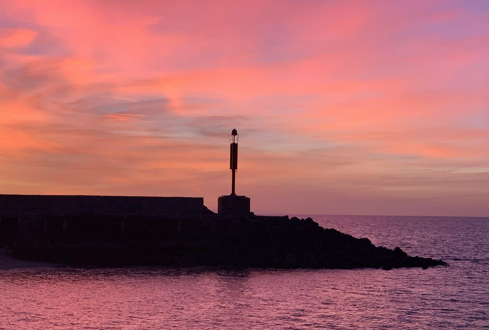 Lighthouse silhouette at sunset with pink sky in Puerto Penasco, Sonora, Mexico
