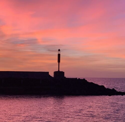 Lighthouse silhouette at sunset with pink sky in Puerto Penasco, Sonora, Mexico