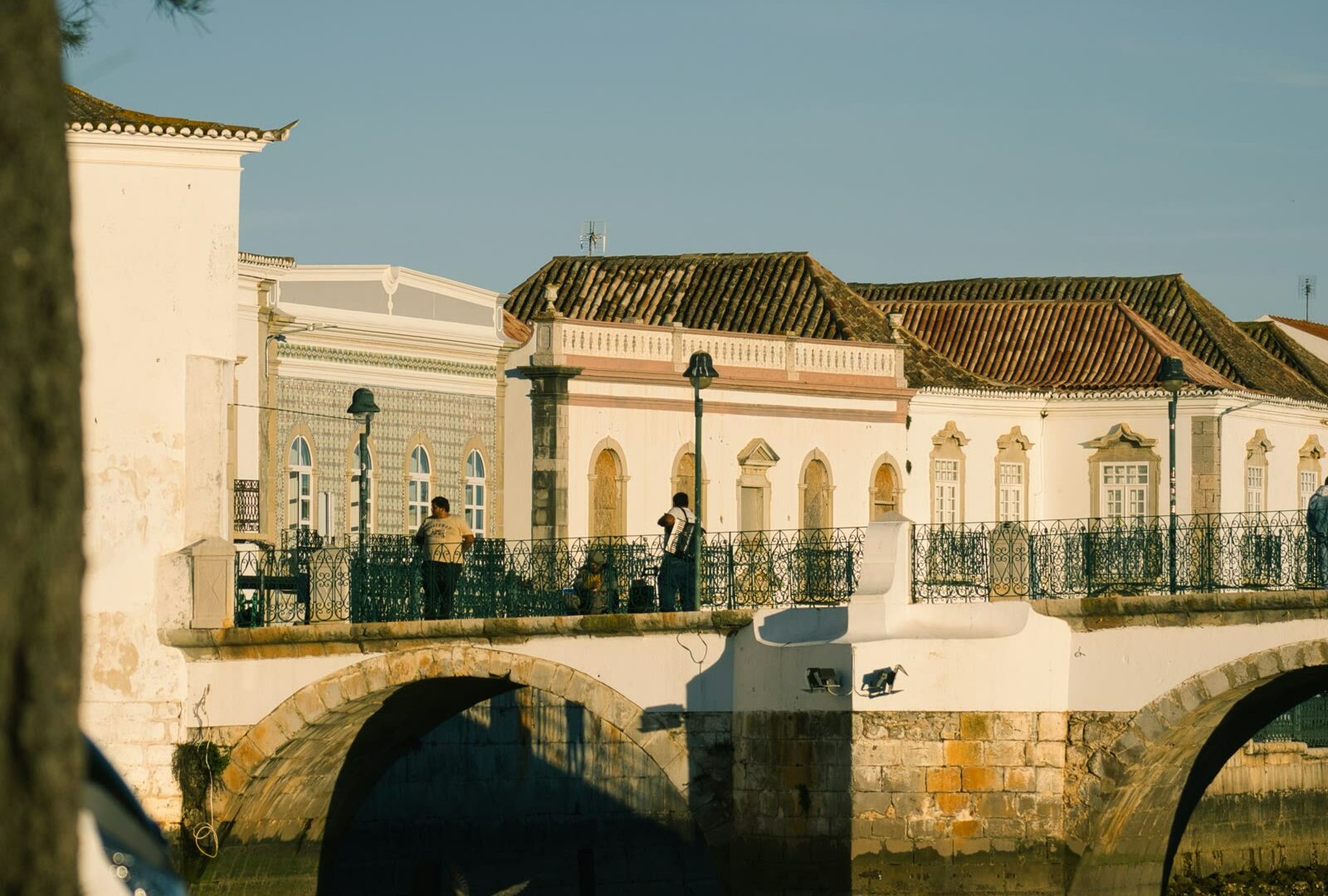 Bridge over water with a building in the background in Tavira, Algarve, Portugal