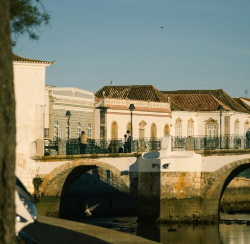 Bridge over water with a building in the background in Tavira, Algarve, Portugal