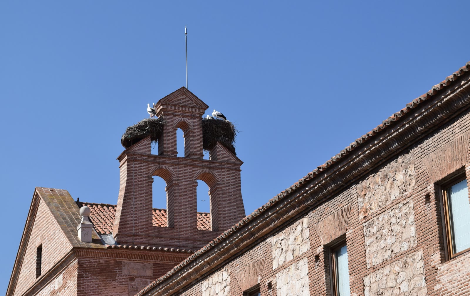 Tall brick building with a clock tower in Alcalá de Henares, Community of Madrid, Spain