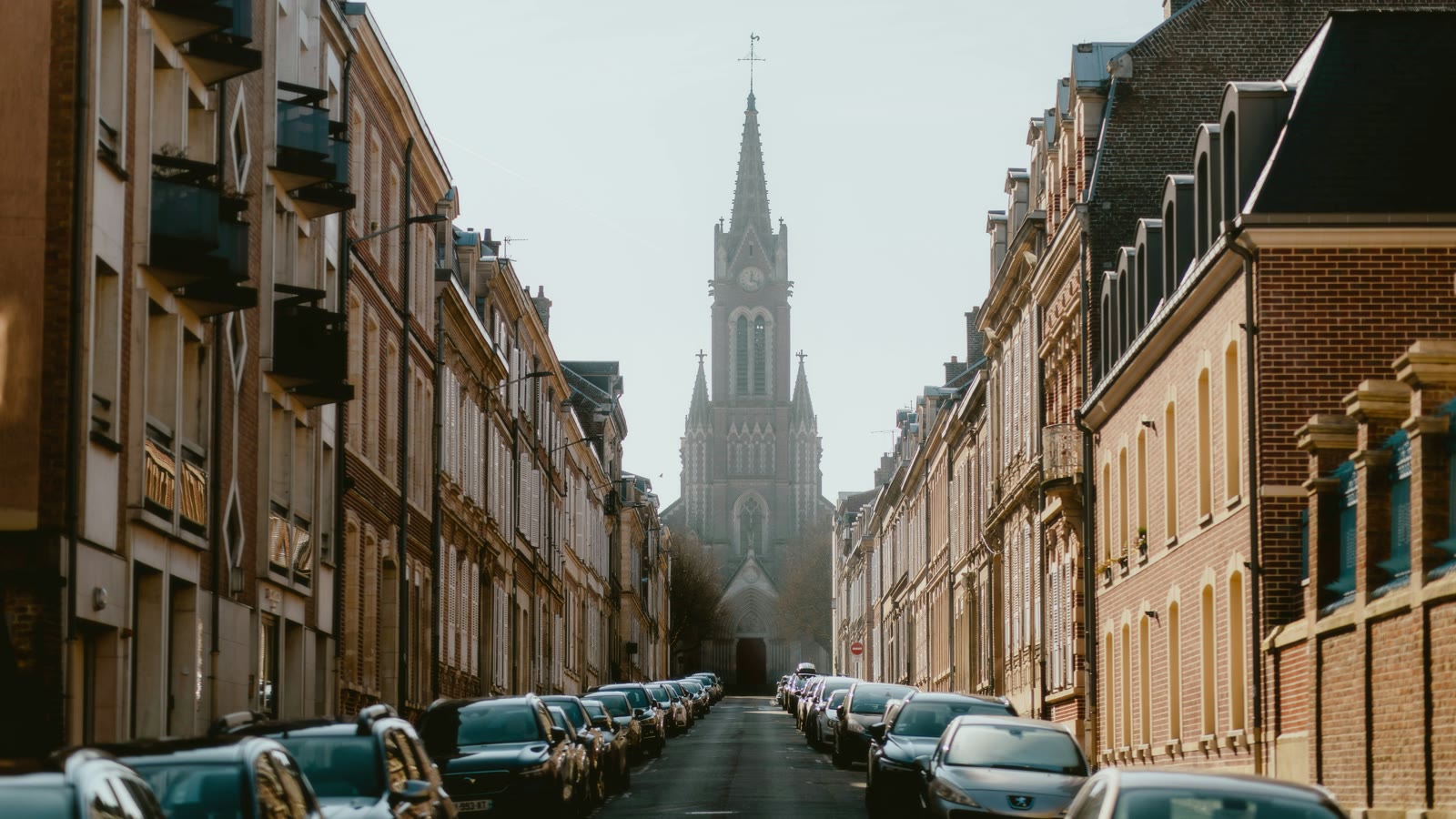 Row of parked cars on a city street in Amiens, Hauts-de-France, France