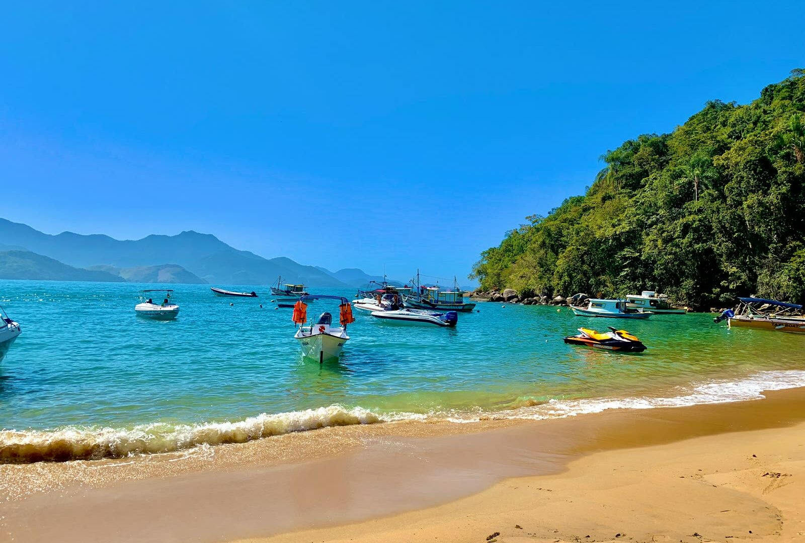 Beach with boats and people in Angra dos Reis, Rio de Janeiro, Brazil