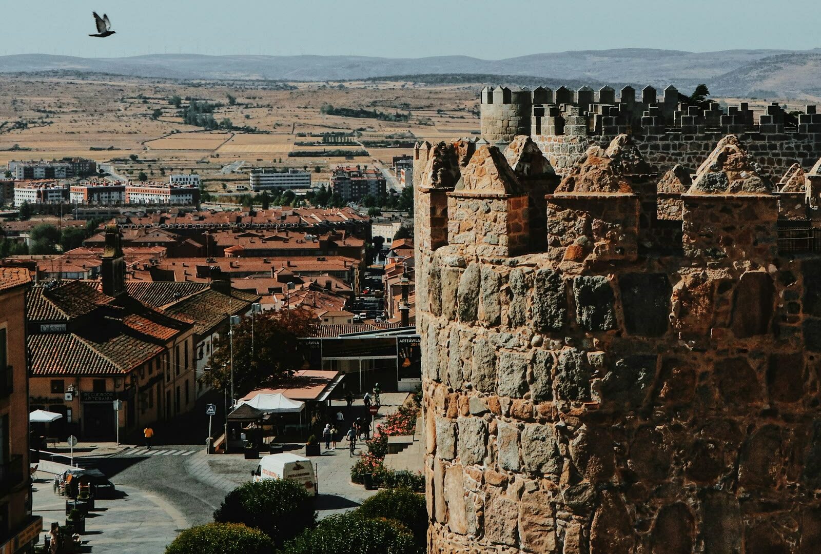 Brown stone building beside the medieval walls in Ávila, Castile and León, Spain