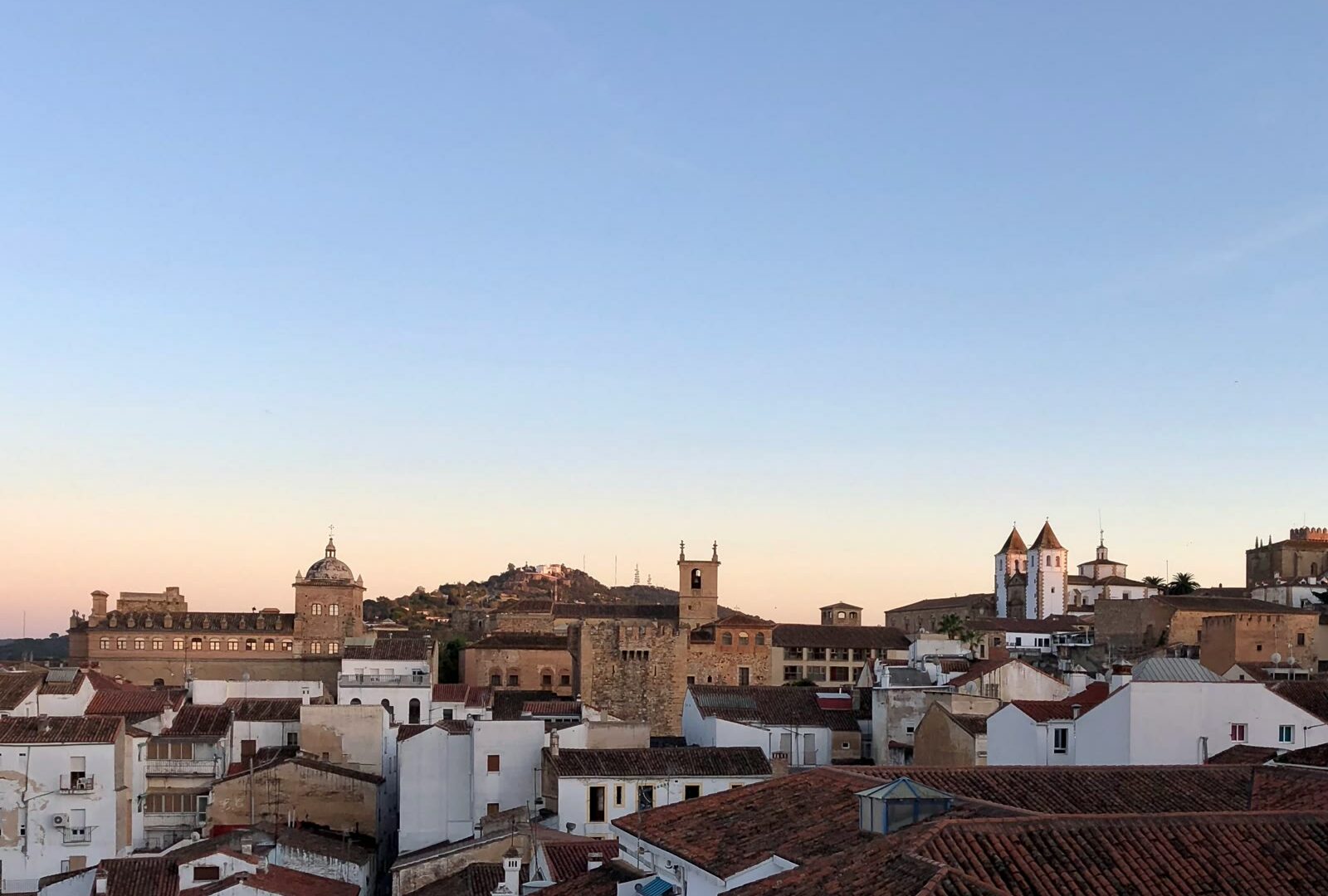 Brown and white stone buildings under blue sky in Cáceres, Extremadura, Spain