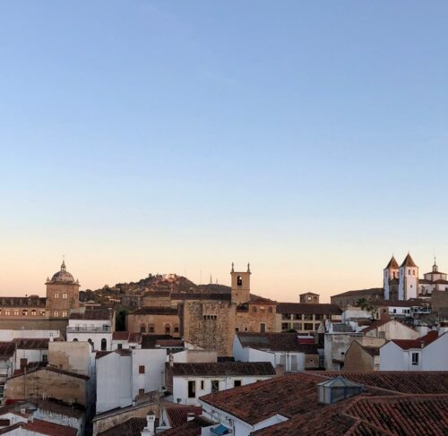 Brown and white stone buildings under blue sky in Cáceres, Extremadura, Spain