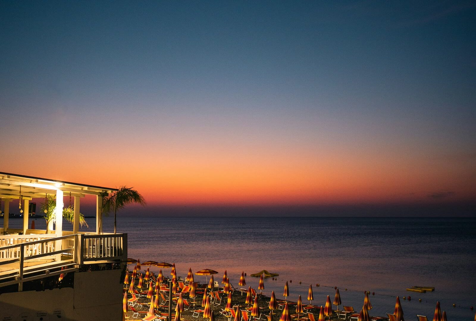 Beach chairs on a beach by the ocean in Catanzaro, Calabria, Italy
