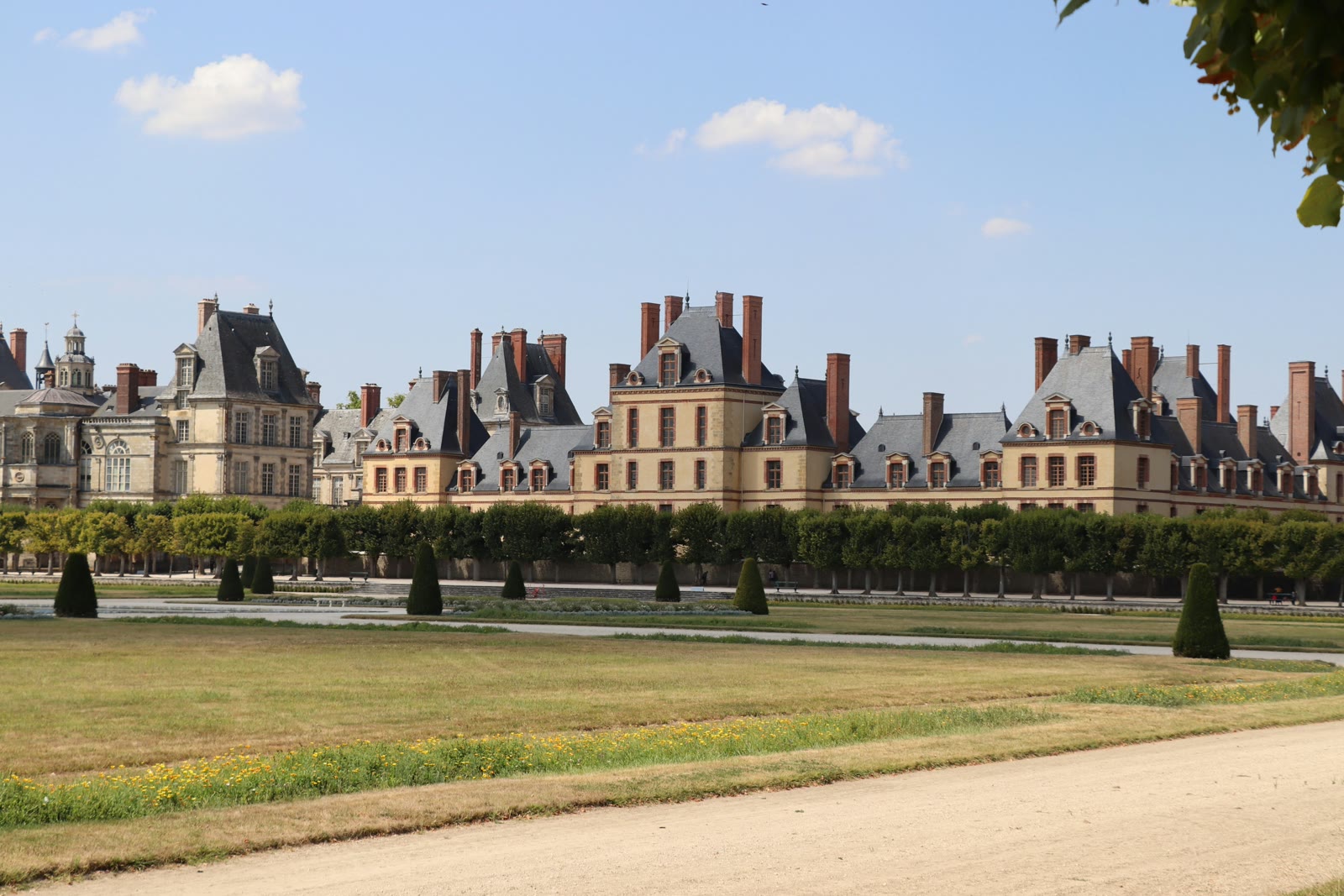 Brown stone building under blue sky in Fontainebleau, Île-de-France, France