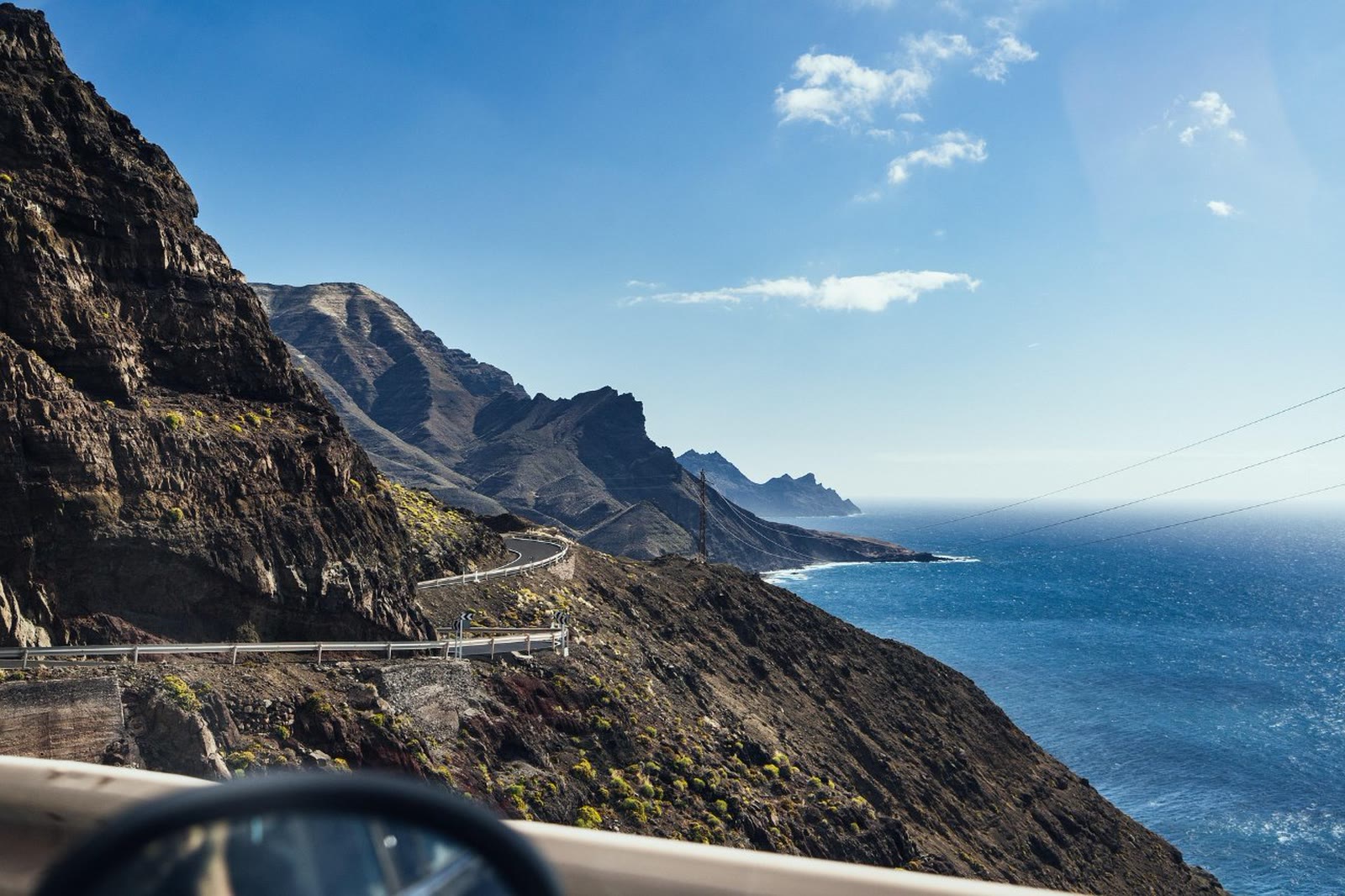 Winding GC-200 coastal road with volcanic cliffs and the Atlantic Ocean in Gran Canaria, Canary Islands