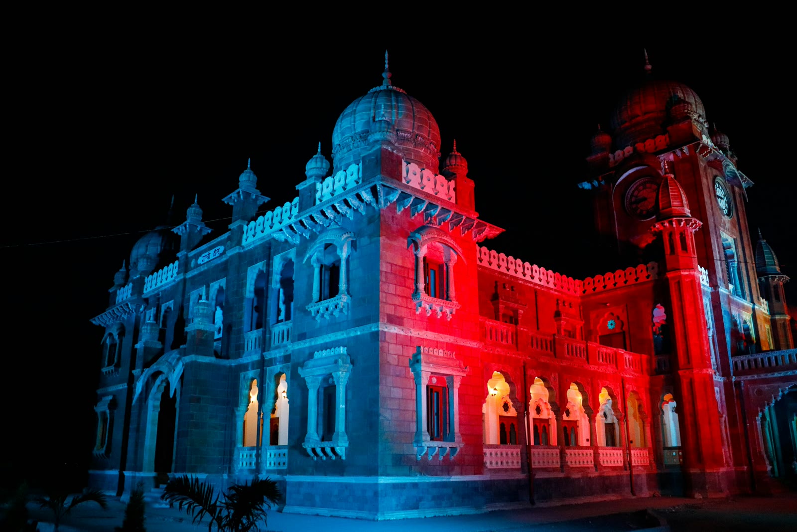 Large building illuminated with red and blue lights in Indore, Madhya Pradesh, India