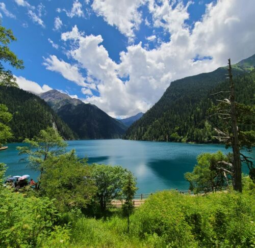 Turquoise lake surrounded by forested mountains in Jiuzhaigou Valley, Sichuan, China