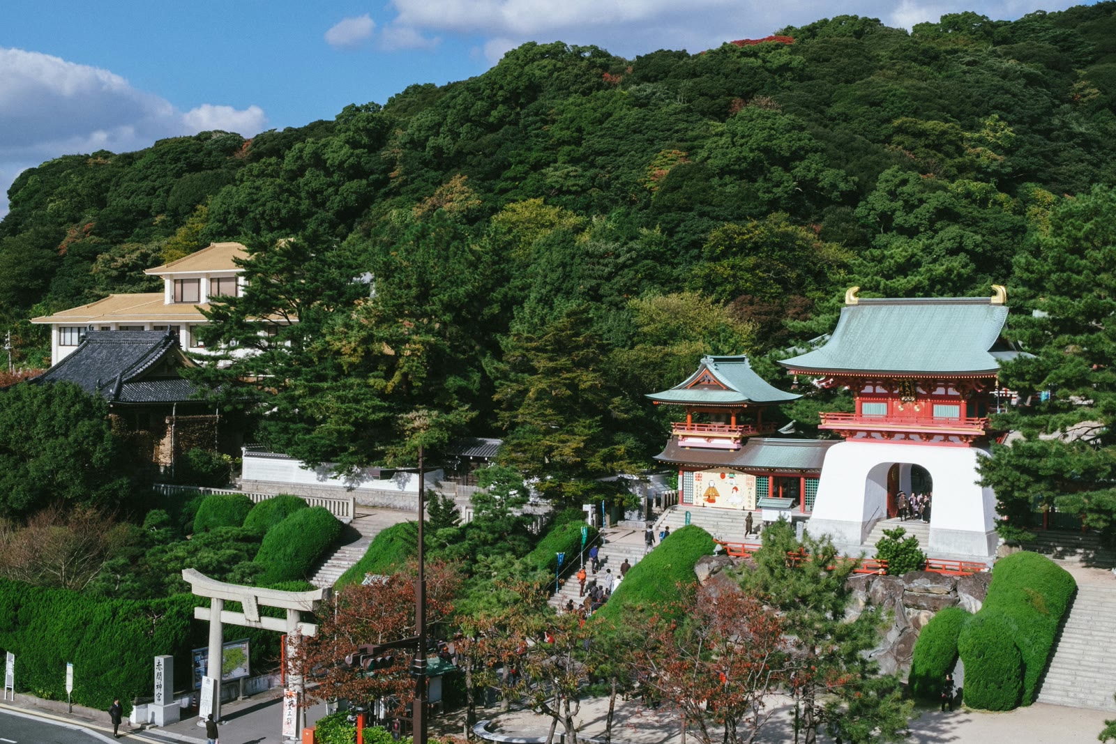 White and red concrete building near green trees in Kitakyushu, Fukuoka, Japan