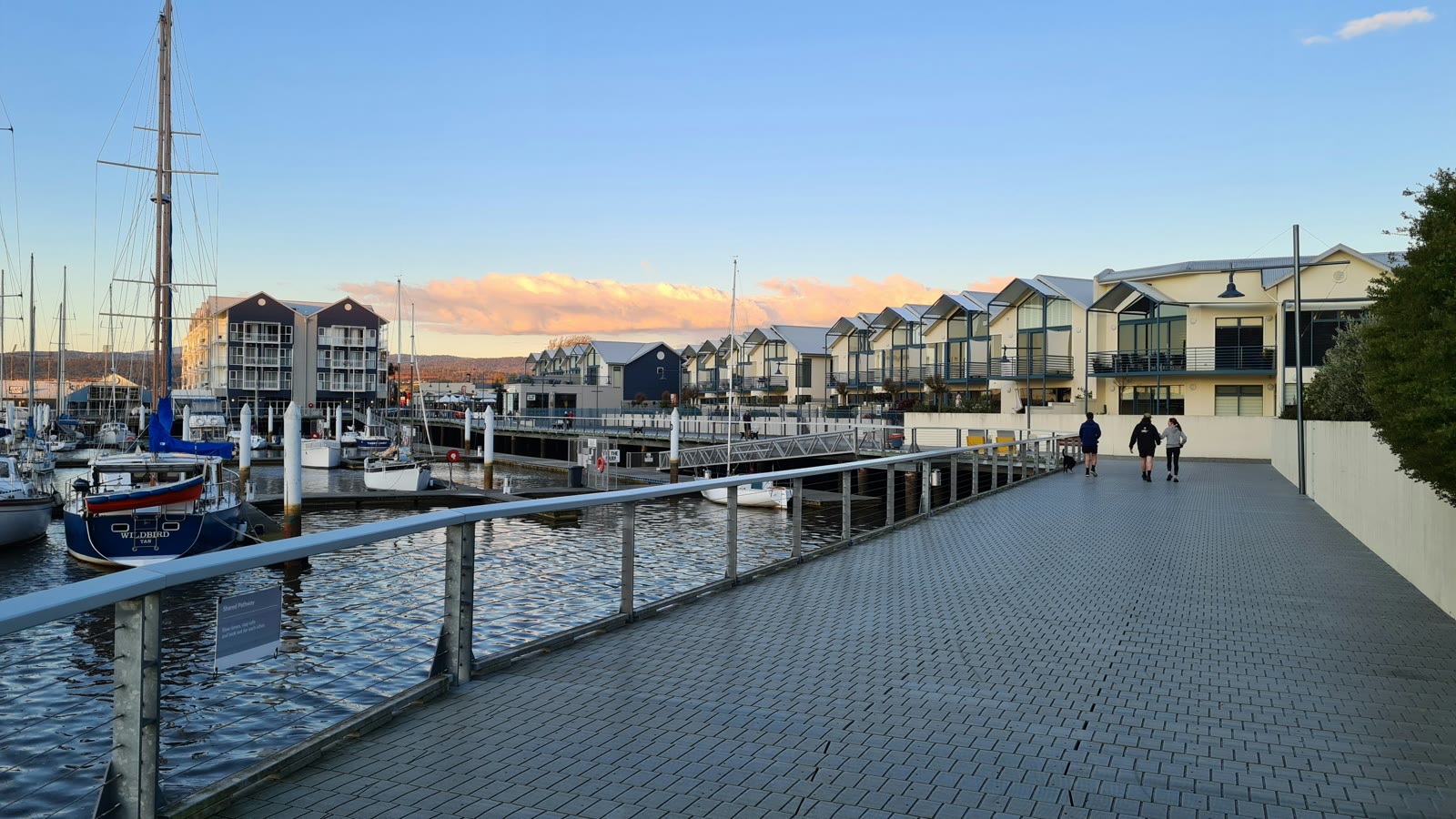 People walking on a walkway beside the water in Launceston, Tasmania, Australia