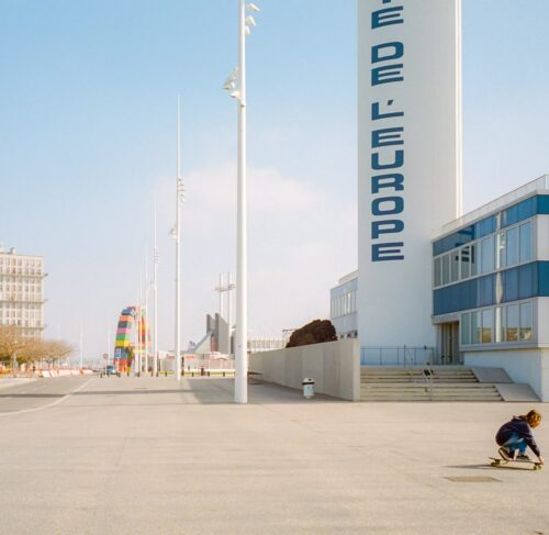 People walking near white and blue buildings in Le Havre, Normandy, France