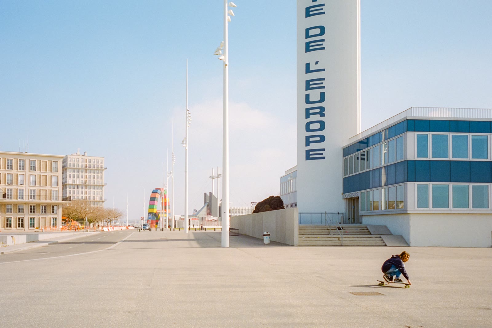 People walking near white and blue buildings in Le Havre, Normandy, France